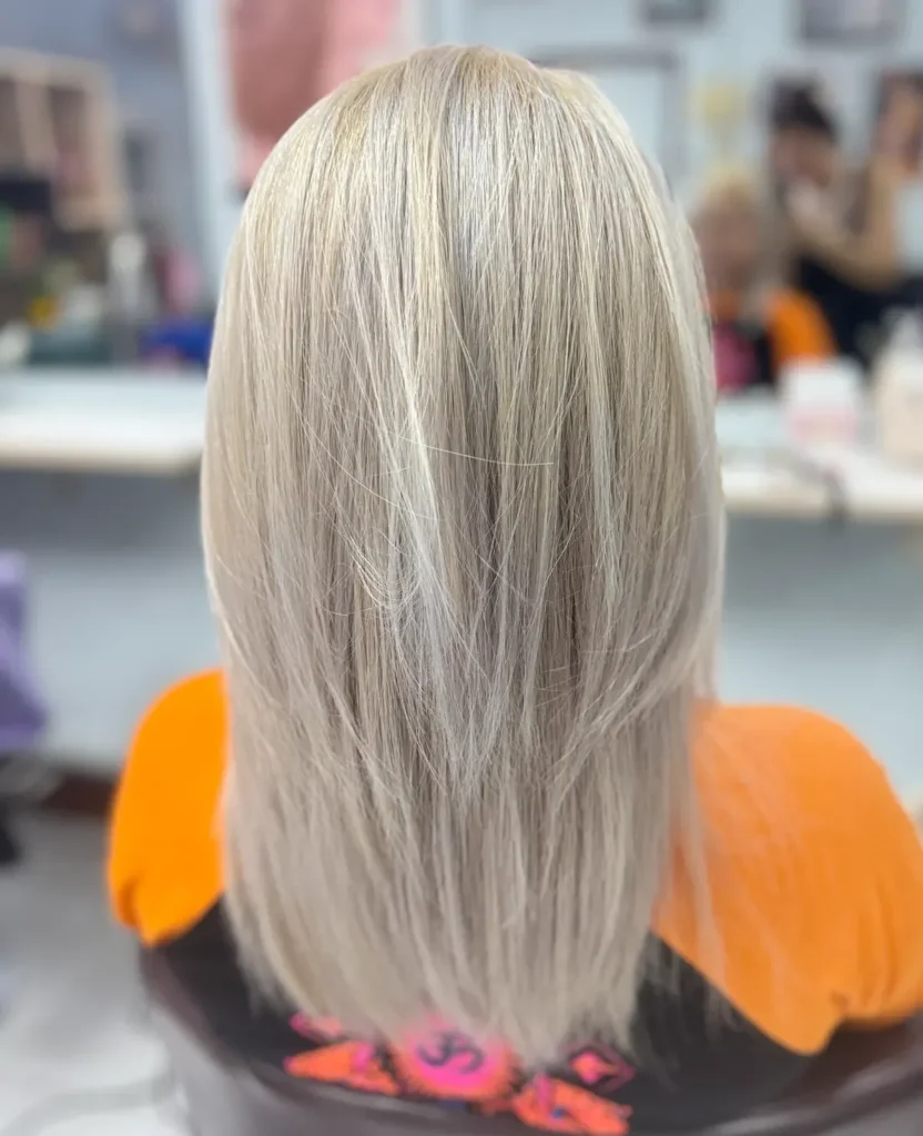 Woman with sleek, straight hair after professional bleaching in Chiang Mai, Thailand.